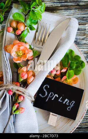 Festive table place setting with spring blossoming branch on wooden background. Copy space Stock Photo