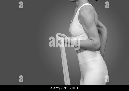 close up of a woman using a resistance band during training and exercise. Stock Photo