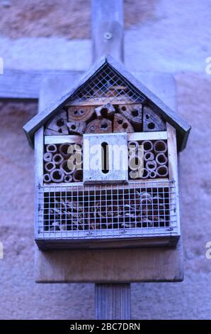 wooden insect hotel in portrait format Stock Photo