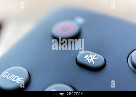 A close up portrarit of a mute button on a remote control of a surround system, dvd or blu-ray player or a television remote control. It is used to st Stock Photo