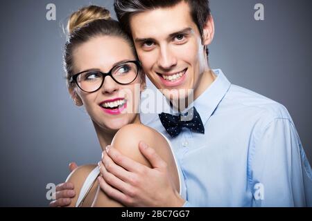 Young couple standing over grey background Stock Photo