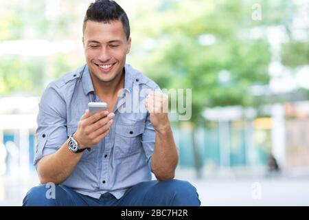 Young man using his smartphone Stock Photo