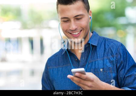 Man listening to music on mobile phone Stock Photo