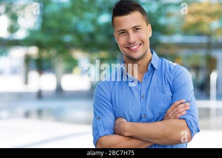 Young man smiling outdoors Stock Photo