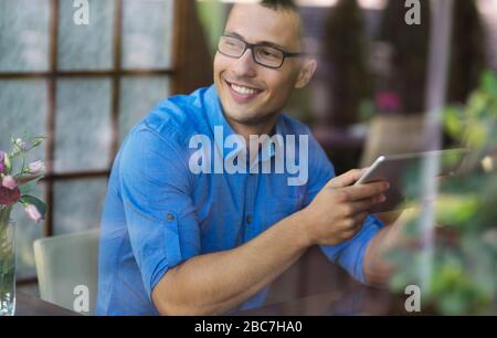 Young man in coffee shop Stock Photo