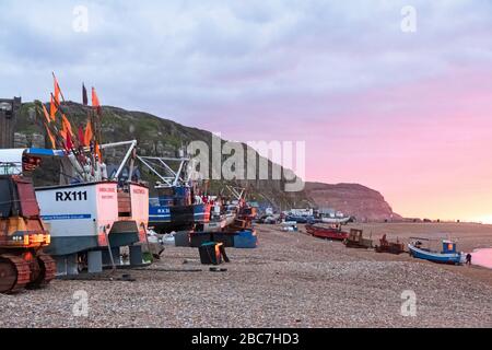 Hastings fishing boat launches at Winter sunrise; as the fishermen put to sea to catch fish during the coronavirus, covid-19 lockdown, East Sussex, UK Stock Photo