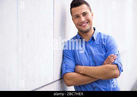 Young man smiling outdoors Stock Photo