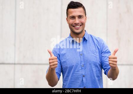 Young man showing thumbs up Stock Photo