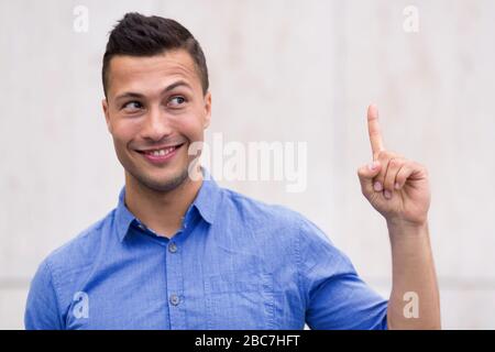 Young man pointing up Stock Photo