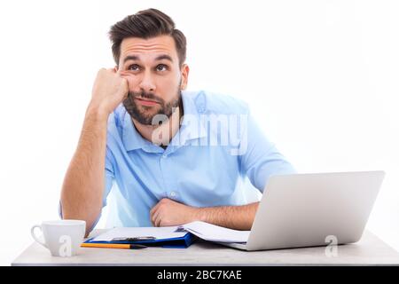 Bored young man at the desk Stock Photo
