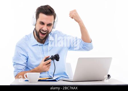 Excited man playing video games Stock Photo