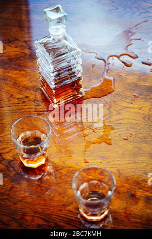 Whiskey old square carafe with two glasses on a varnished table top view Stock Photo