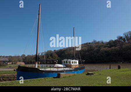 Two Masted Sailing Boat in a Dock in the Quay at Cotehele on the River Tamar in Rural Cornwall, England, UK Stock Photo