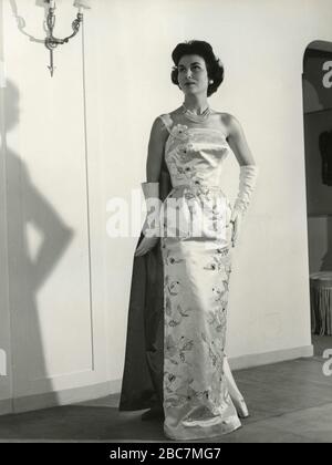 Model from the 1960s presenting an outfit with elegant evening dress and  long gloves, Italy Stock Photo - Alamy