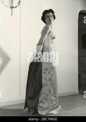 Model from the 1960s presenting an outfit with elegant evening dress and  long gloves, Italy Stock Photo - Alamy