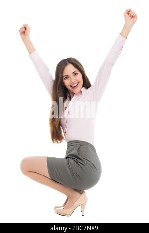 Beautiful woman crouching with arms raised Stock Photo