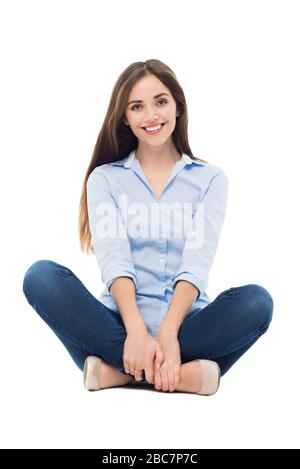 Young woman sitting on white background Stock Photo