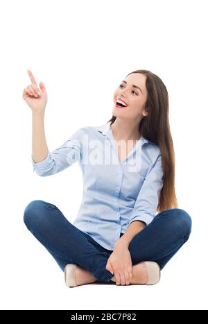 Young woman sitting on white background Stock Photo