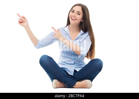 Happy young woman sitting on sand at beach in summer Stock Photo - Alamy