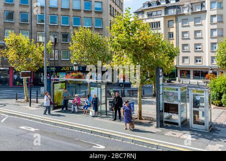Bus-stop with waiting travellers near central railway station Luxembourg city Stock Photo
