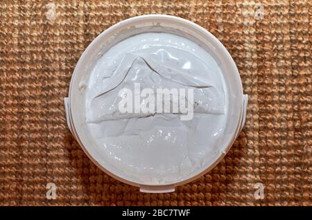 Bucket of white spackle compound - shot from top Stock Photo