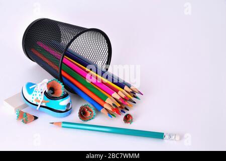 Pencils in a glass, sharpener and eraser on a white background Stock Photo