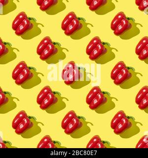 Seamless pattern of red pepper with shadow on yellow background. Flat lay, Food texture. Stock Photo