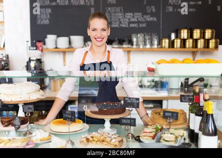 Proud young female cafe owner Stock Photo