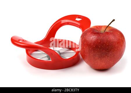 Red device for slicing apples isolated on white background. High resolution photo. Full depth of field. Stock Photo