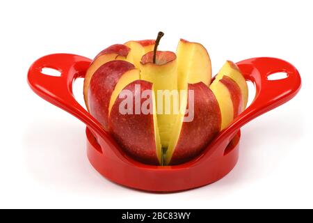 Red device for slicing apples isolated on white background. High resolution photo. Full depth of field. Stock Photo