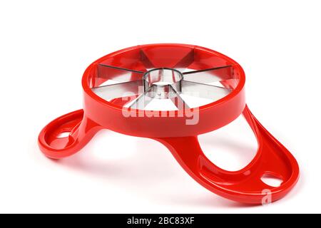 Red device for slicing apples isolated on white background. High resolution photo. Full depth of field. Stock Photo