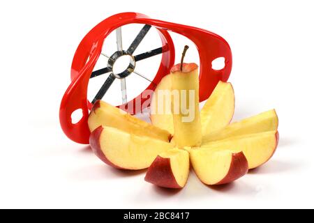 Red device for slicing apples isolated on white background. High resolution photo. Full depth of field. Stock Photo