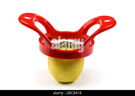 Red device for slicing apples isolated on white background. High resolution photo. Full depth of field. Stock Photo