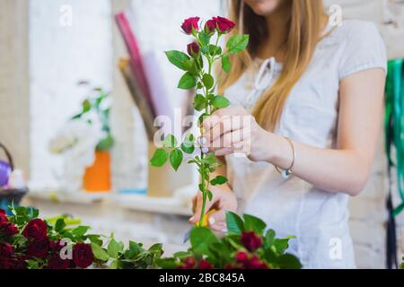 Professional florist working with flowers at studio, shop Stock Photo