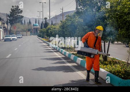 The Iranian health ministry, provincial fire department and municipal staffs disinfect the streets and other public places against Coronavirus(Covid-19) using machinery and mobile pumps in Shiraz, Fars province, Iran. April, 2020. Stock Photo