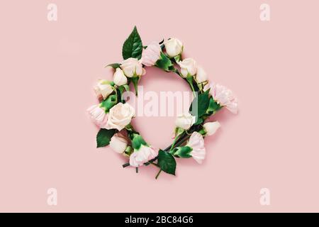Flowers composition. Circle made of roses on pink background. Place for the text. Stock Photo