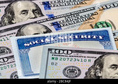 Closeup of Social Security benefits identification card with 100 dollar bills Stock Photo