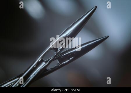 Sewing machine needles and a threaded metal at the blurry background Stock Photo
