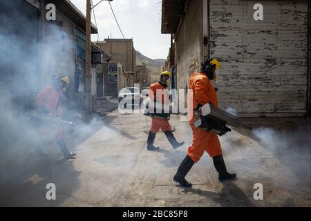 The Iranian health ministry, provincial fire department and municipal staffs disinfect the streets and other public places against Coronavirus(Covid-19) using machinery and mobile pumps in Shiraz, Fars province, Iran. April, 2020. Stock Photo