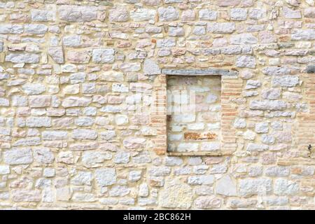 Detailed stonewall texture of a little house in a small town of Umbria in the central part of Italy Stock Photo