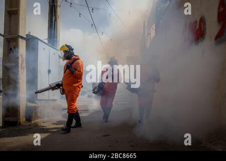 The Iranian health ministry, provincial fire department and municipal staffs disinfect the streets and other public places against Coronavirus(Covid-19) using machinery and mobile pumps in Shiraz, Fars province, Iran. April, 2020. Stock Photo