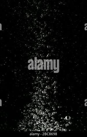 Black and white explosion of bubbles moving in water Stock Photo