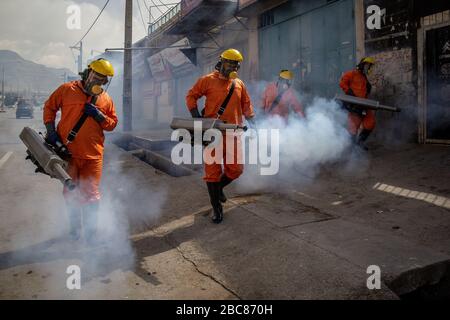 The Iranian health ministry, provincial fire department and municipal staffs disinfect the streets and other public places against Coronavirus(Covid-19) using machinery and mobile pumps in Shiraz, Fars province, Iran. April, 2020. Stock Photo