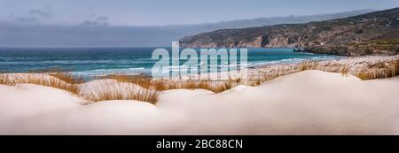 Panoramic costal view of Praia do Guincho Beach with Cresmina Dunes in foreground. Cascais, Portugal. Atlantic ocean spot for surfing, windsurfing and Stock Photo