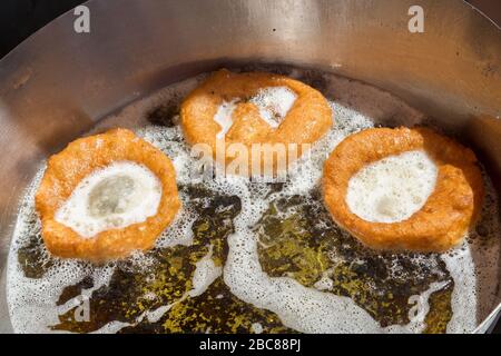 Frying Portuguese doughnuts at Sunday market, Loule, Algarve, Portugal Stock Photo
