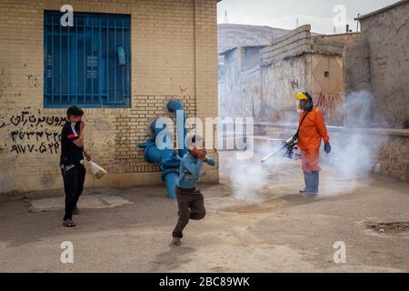 The Iranian health ministry, provincial fire department and municipal staffs disinfect the streets and other public places against Coronavirus(Covid-19) using machinery and mobile pumps in Shiraz, Fars province, Iran. April, 2020. Stock Photo