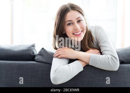Young woman relaxing on sofa Stock Photo