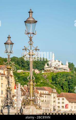 Wrought iron lantern at the Lucerne old town with the Chateau Guetsch in the background, Switzerland Stock Photo