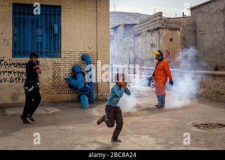 The Iranian health ministry, provincial fire department and municipal staffs disinfect the streets and other public places against Coronavirus(Covid-19) using machinery and mobile pumps in Shiraz, Fars province, Iran. April, 2020. Stock Photo