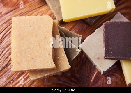 Handmade soap bars on wooden board. varieties of spa organic soap. Craft natural soap on wooden table Stock Photo